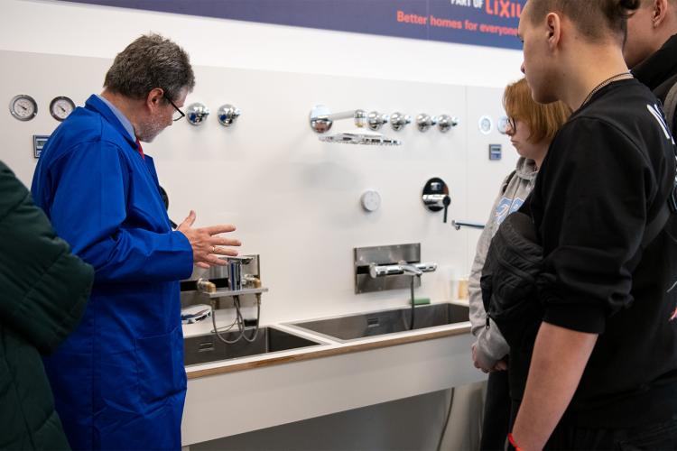 Na zdjęciu grupa ludzi zwiedzająca Laboratorium Instalacji Sanitarnych na Politechnice Warszawskiej