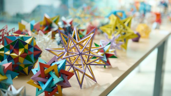 Na zdjęciu bryły geometryczne leżące na stolikach