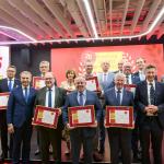 Na zdjęciu grupa osób - reprezentanci najlepszych uczelni w Polsce z dyplomami