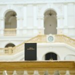 Na zdjęciu: okładka pracy magisterskiej na tle Dużej Auli w Gmachu Głównym PW